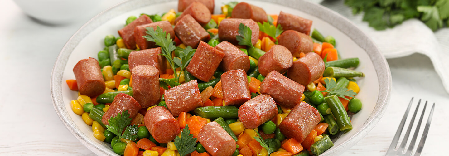 Stir Fry chicken franks and mixed vegetables with corn